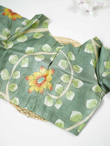 Tussar This elegant leaf green Tussar blouse features finely stitched hand-painted Pen Kalamkari floral designs. The intricate artwork reflects traditional craftsmanship with beautiful artistic detailing. The fresh leaf green shade enhances the painted flowers, giving it a natural and graceful appeal. Perfect for ethnic wear, it creates a stylish and uniquely handcrafted traditional look. Kamini - Tussar Silk Saree | Hand Embroidered - Manoranjitham Weaves - Handloom Store