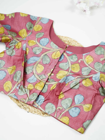 Tussar This elegant pink Tussar blouse features finely stitched hand-painted Pen Kalamkari floral designs. The delicate artwork showcases traditional craftsmanship with graceful and artistic detailing. The soft pink shade enhances the hand-painted flowers, giving it a charming ethnic appeal. Perfect for pairing with sarees, it creates a stylish and beautifully handcrafted traditional look. Kusuma - Tussar Silk Saree | Hand Embroidered - Manoranjitham Weaves - Handloom Store