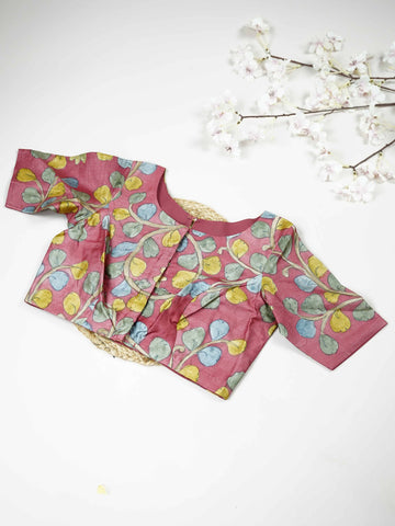 Tussar This elegant pink Tussar blouse features finely stitched hand-painted Pen Kalamkari floral designs. The delicate artwork showcases traditional craftsmanship with graceful and artistic detailing. The soft pink shade enhances the hand-painted flowers, giving it a charming ethnic appeal. Perfect for pairing with sarees, it creates a stylish and beautifully handcrafted traditional look. Kusuma - Tussar Silk Saree | Hand Embroidered - Manoranjitham Weaves - Handloom Store