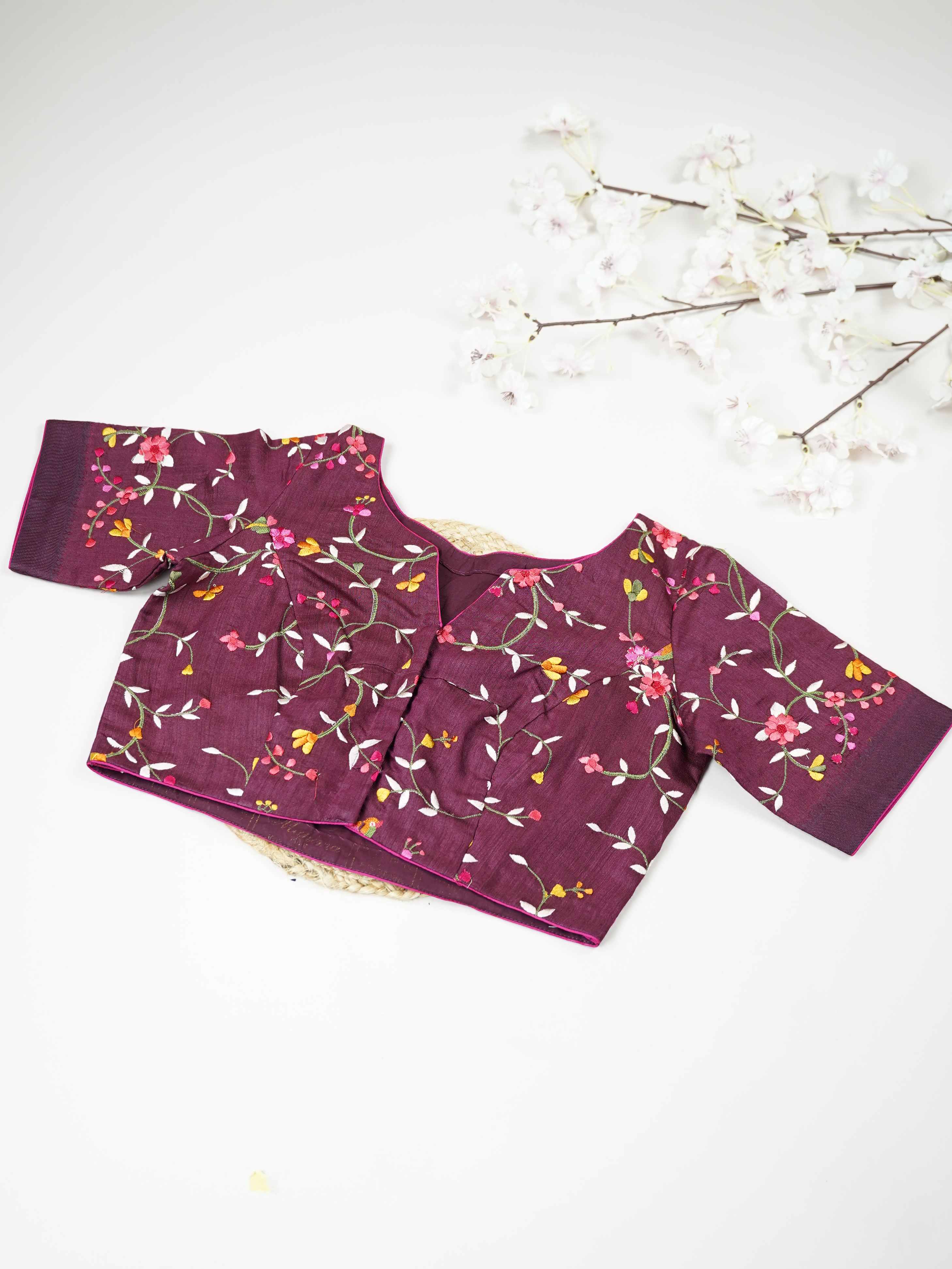Tussar This elegant dark wine Tussar designer blouse features finely stitched contrast hand embroidery work. The front and back are fully adorned with rich embroidery, showcasing detailed craftsmanship. The deep wine shade enhances the intricate design, giving it a regal and graceful appeal. Perfect for ethnic wear, it creates a bold, stylish, and beautifully handcrafted traditional look. Shobhita - Tussar Silk Saree | Hand Embroidered - Manoranjitham Weaves - Handloom Store