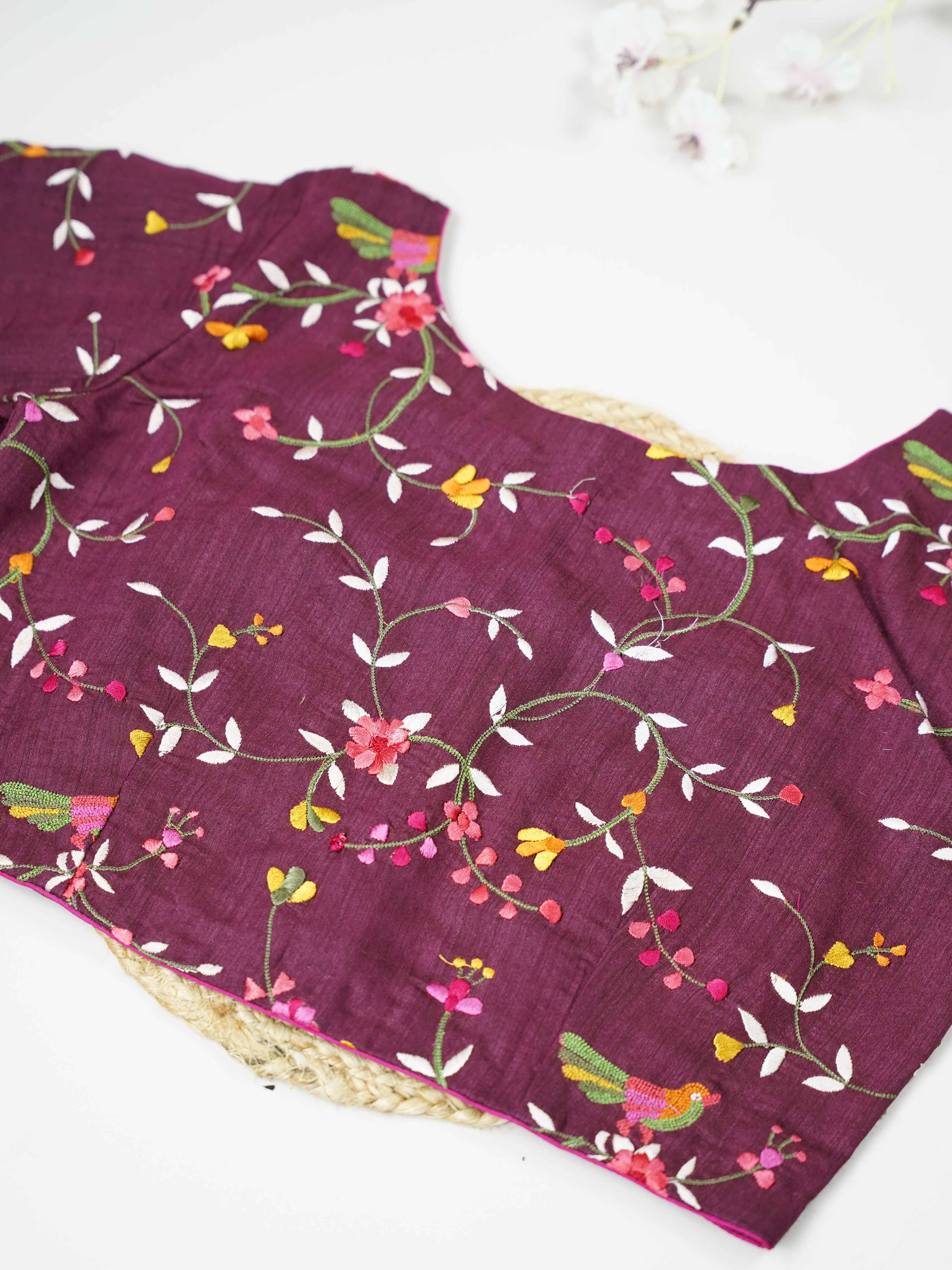Tussar This elegant dark wine Tussar designer blouse features finely stitched contrast hand embroidery work. The front and back are fully adorned with rich embroidery, showcasing detailed craftsmanship. The deep wine shade enhances the intricate design, giving it a regal and graceful appeal. Perfect for ethnic wear, it creates a bold, stylish, and beautifully handcrafted traditional look. Shobhita - Tussar Silk Saree | Hand Embroidered - Manoranjitham Weaves - Handloom Store