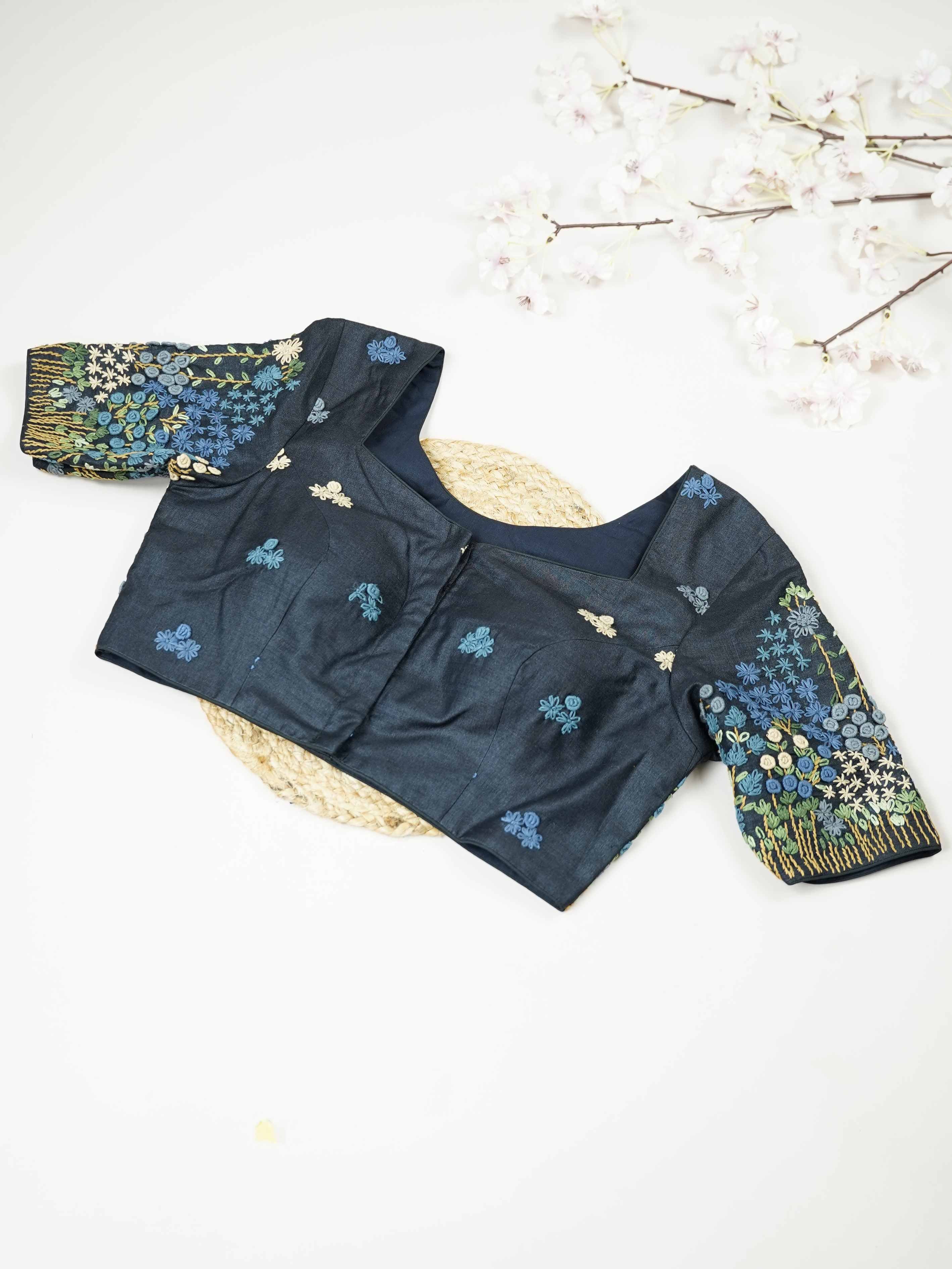 Tussar This elegant black Tussar designer blouse features beautifully stitched contrast hand embroidery work. The front is adorned with small floral motifs, adding a subtle yet graceful charm. The back is richly designed with full embroidery, showcasing intricate craftsmanship.br data-start=275 data-end=278Perfect for ethnic wear, it creates a bold, stylish, and eye-catching traditional look. Avarni - Tussar Silk Saree | Hand Embroidered - Manoranjitham Weaves - Handloom Store