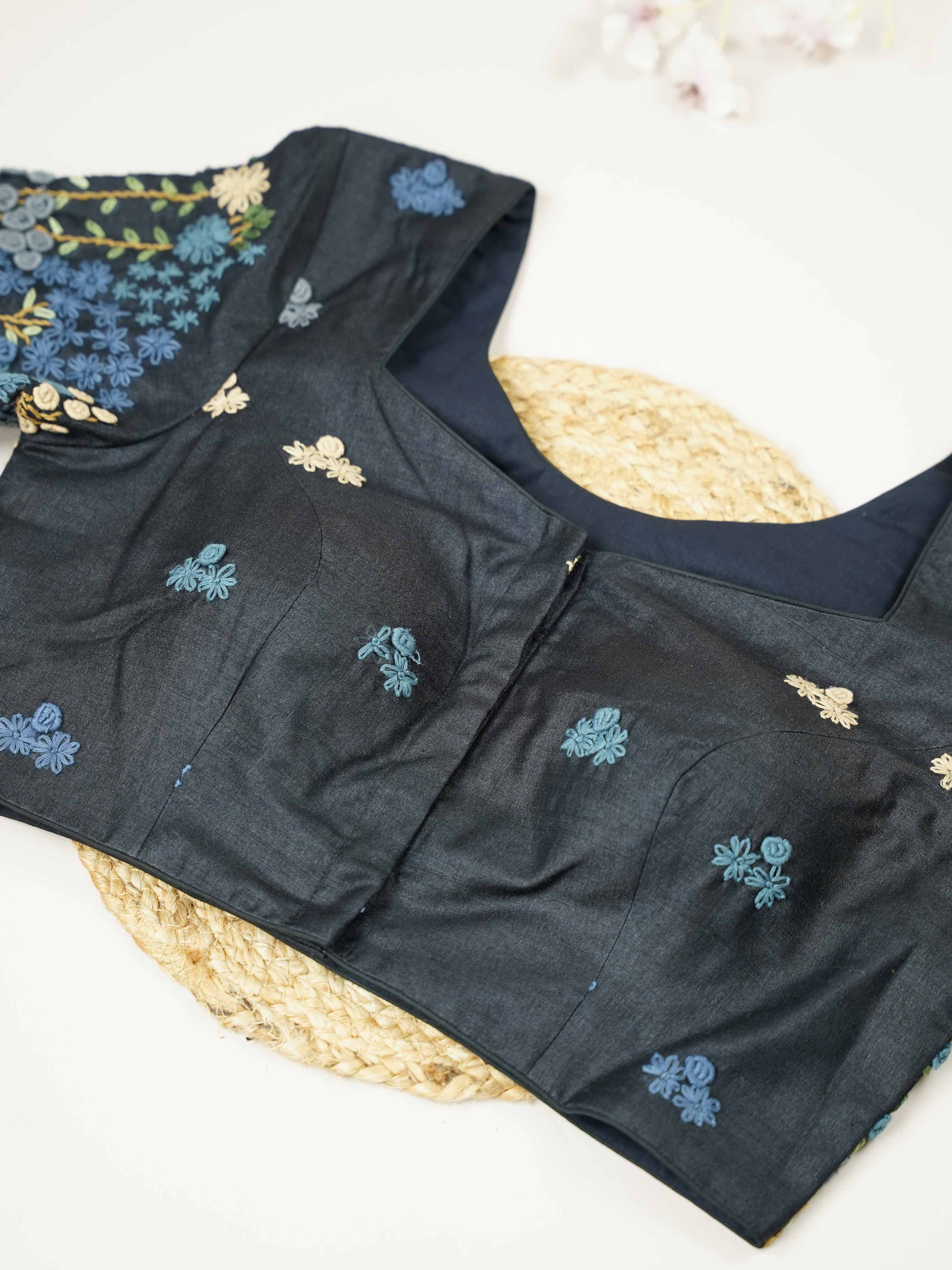 Tussar This elegant black Tussar designer blouse features beautifully stitched contrast hand embroidery work. The front is adorned with small floral motifs, adding a subtle yet graceful charm. The back is richly designed with full embroidery, showcasing intricate craftsmanship.br data-start=275 data-end=278Perfect for ethnic wear, it creates a bold, stylish, and eye-catching traditional look. Avarni - Tussar Silk Saree | Hand Embroidered - Manoranjitham Weaves - Handloom Store