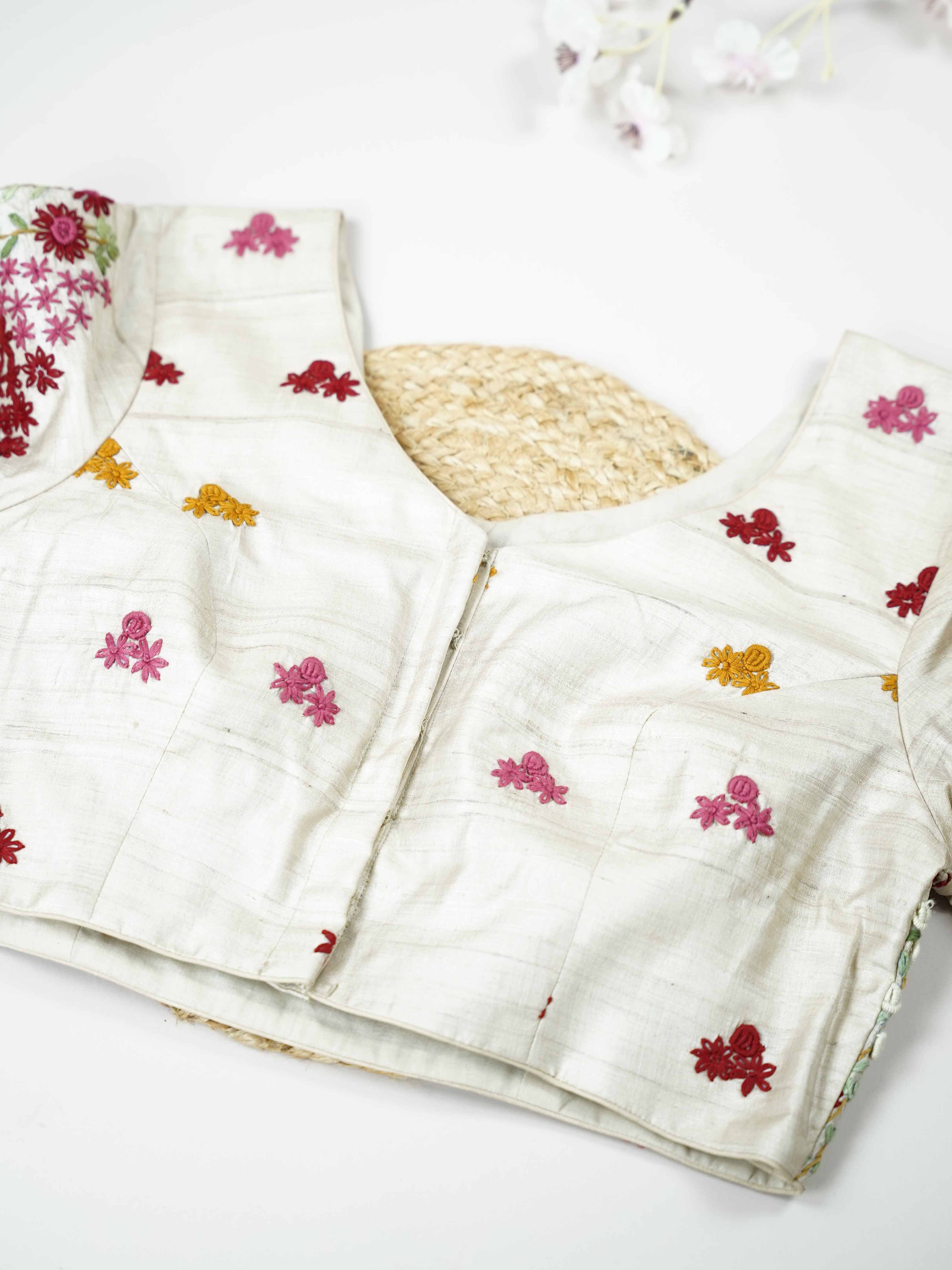 Tussar This elegant white Tussar blouse features finely stitched hand Kantha work that reflects traditional craftsmanship. The delicate embroidery adds subtle texture and artistic charm to the soft fabric. Its classic white shade enhances the intricate Kantha detailing with a graceful appeal. Perfect for pairing with ethnic sarees, it offers a timeless and elegant traditional look. Inara - Tussar Silk Saree | Hand Embroidered - Manoranjitham Weaves - Handloom Store