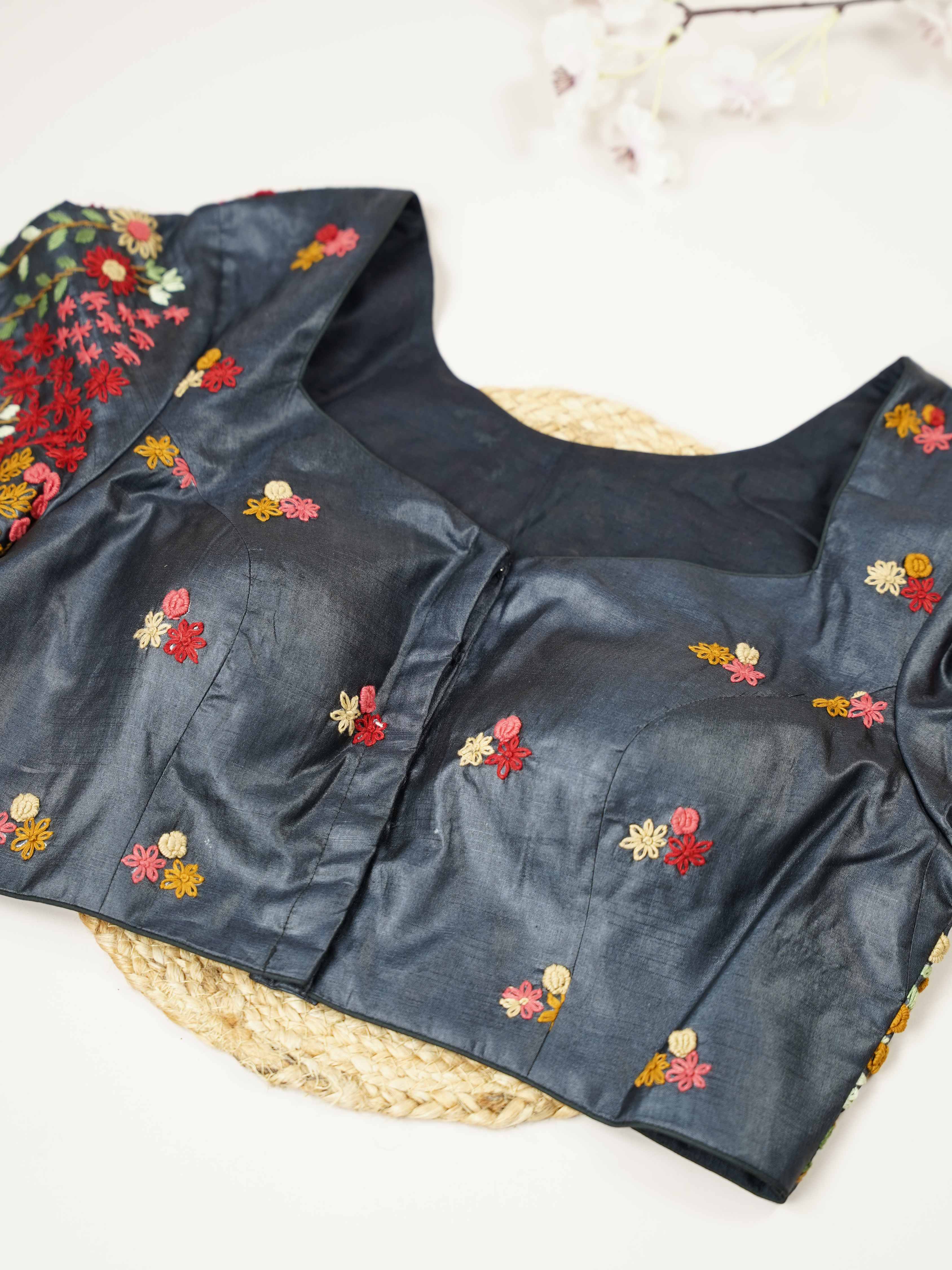 Tussar This elegant black Tussar blouse features finely stitched hand embroidery work.br data-start=79 data-end=82The front is delicately designed with small floral motifs, adding a subtle and graceful charm. Arinya - Tussar Silk Saree | Hand Embroidered - Manoranjitham Weaves - Handloom Store