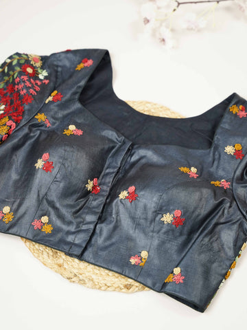 Tussar This elegant black Tussar blouse features finely stitched hand embroidery work.br data-start=79 data-end=82The front is delicately designed with small floral motifs, adding a subtle and graceful charm. Arinya - Tussar Silk Saree | Hand Embroidered - Manoranjitham Weaves - Handloom Store