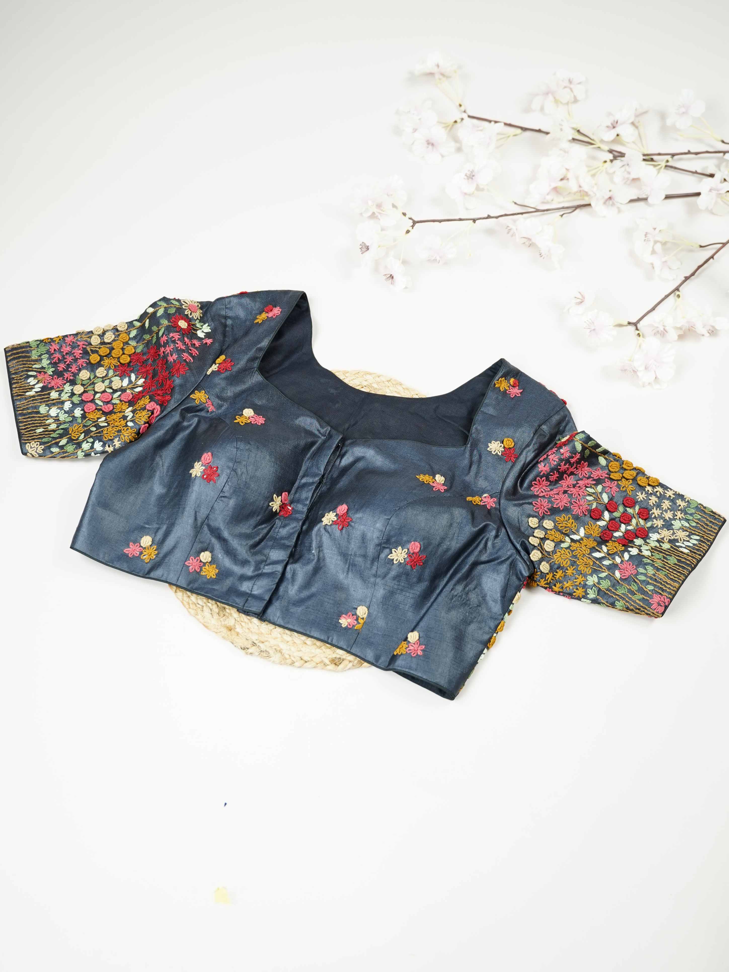 Tussar This elegant black Tussar blouse features finely stitched hand embroidery work.br data-start=79 data-end=82The front is delicately designed with small floral motifs, adding a subtle and graceful charm. Arinya - Tussar Silk Saree | Hand Embroidered - Manoranjitham Weaves - Handloom Store
