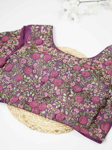 Tussar This elegant wine-coloured Tussar blouse features finely stitched hand embroidery work. The front is delicately designed with small floral motifs, adding a subtle feminine charm. Nyra - Tussar Silk Saree | Hand Embroidered - Manoranjitham Weaves - Handloom Store