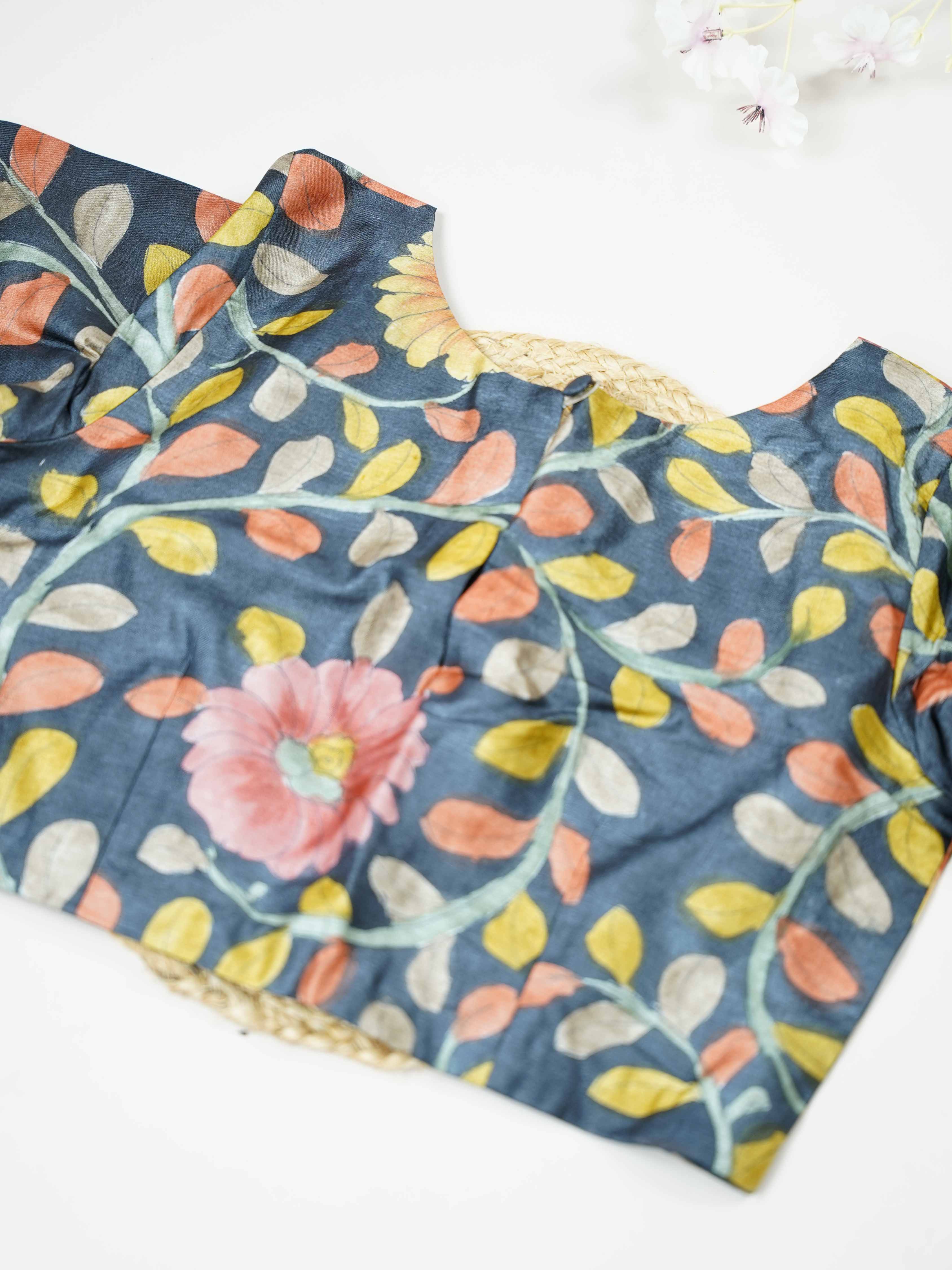 Tussar This elegant Tussar blouse features beautifully stitched Pen Kalamkari work that reflects traditional artistry.  The intricate hand-drawn patterns add a rich cultural and handcrafted appeal. Its fine stitching enhances the detailed Kalamkari motifs, giving it a refined finish. Perfect to pair with ethnic sarees, it brings a graceful and artistic charm to the overall look. Bhumika - Tussar Silk Saree | Hand Embroidered - Manoranjitham Weaves - Handloom Store