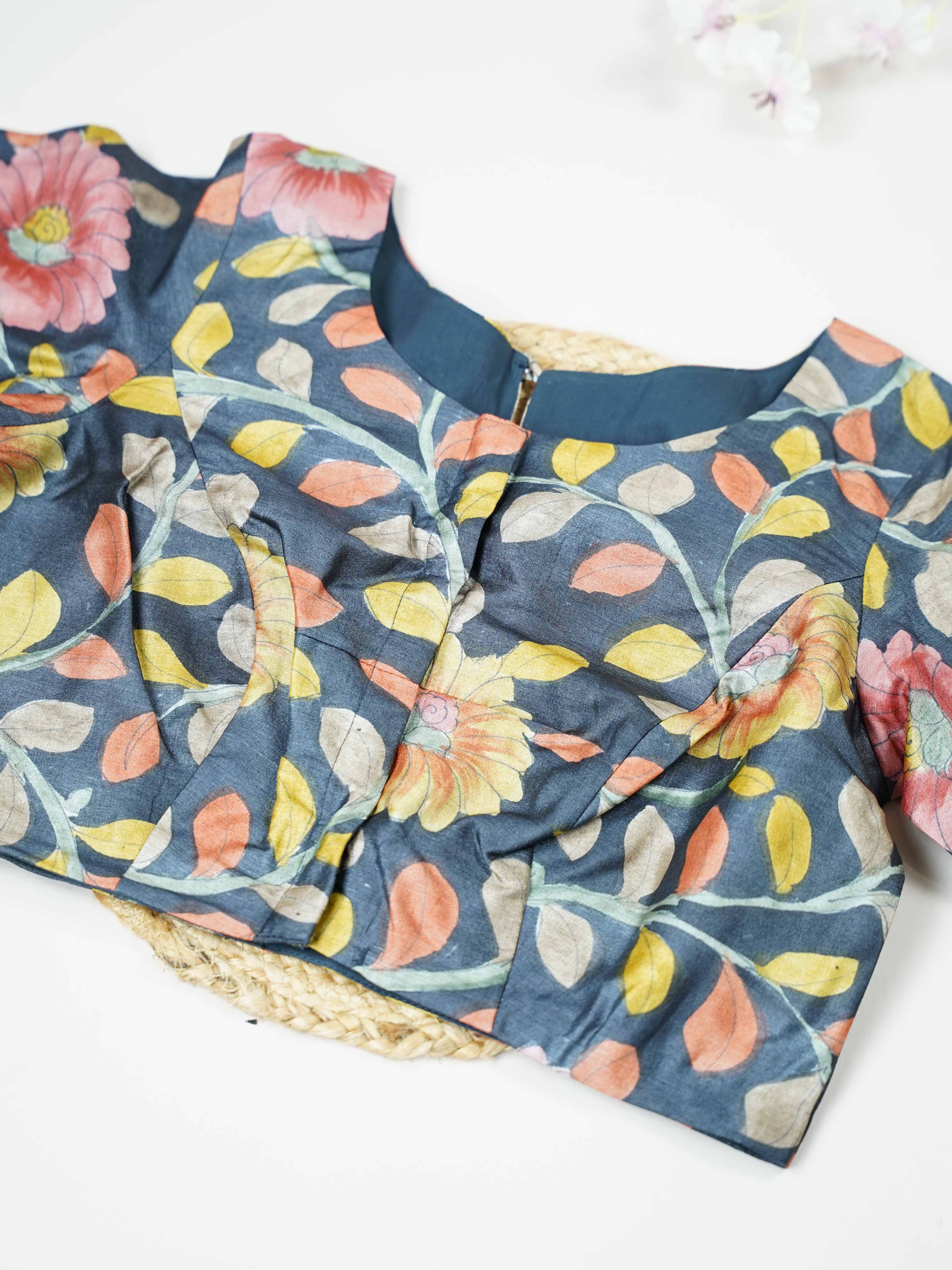 Tussar This elegant Tussar blouse features beautifully stitched Pen Kalamkari work that reflects traditional artistry.  The intricate hand-drawn patterns add a rich cultural and handcrafted appeal. Its fine stitching enhances the detailed Kalamkari motifs, giving it a refined finish. Perfect to pair with ethnic sarees, it brings a graceful and artistic charm to the overall look. Bhumika - Tussar Silk Saree | Hand Embroidered - Manoranjitham Weaves - Handloom Store