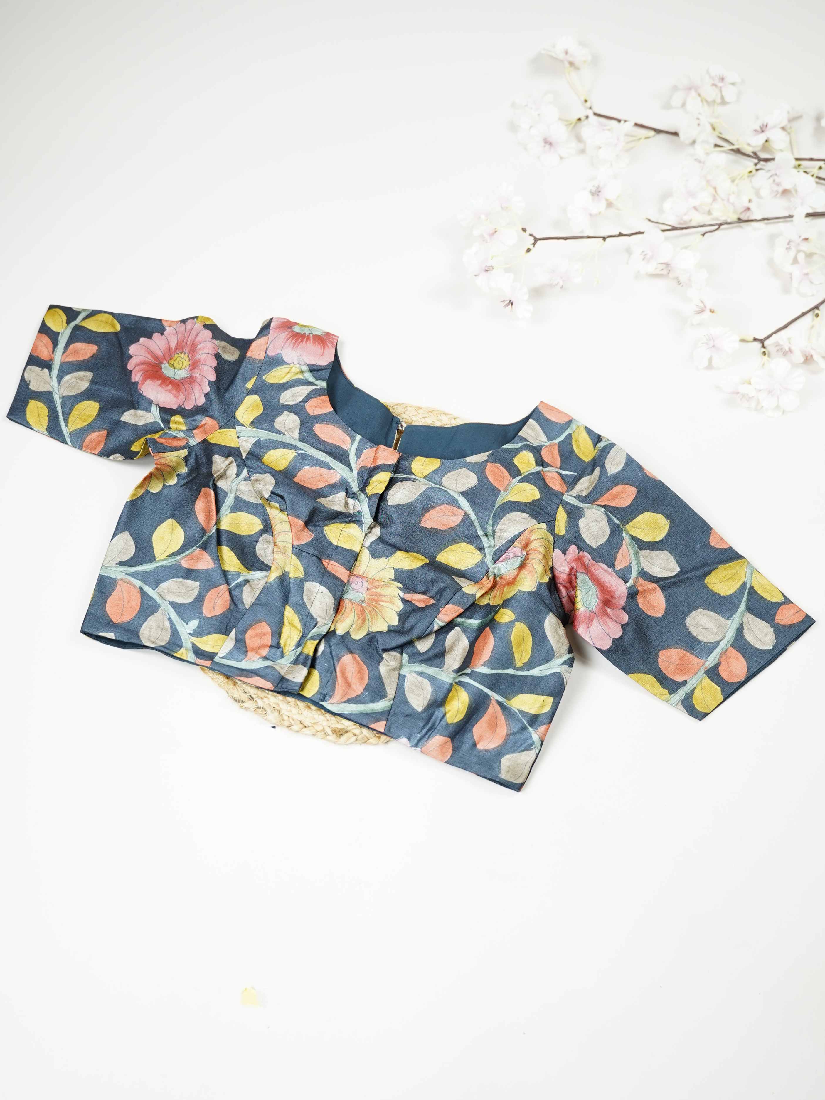 Tussar This elegant Tussar blouse features beautifully stitched Pen Kalamkari work that reflects traditional artistry.  The intricate hand-drawn patterns add a rich cultural and handcrafted appeal. Its fine stitching enhances the detailed Kalamkari motifs, giving it a refined finish. Perfect to pair with ethnic sarees, it brings a graceful and artistic charm to the overall look. Bhumika - Tussar Silk Saree | Hand Embroidered - Manoranjitham Weaves - Handloom Store