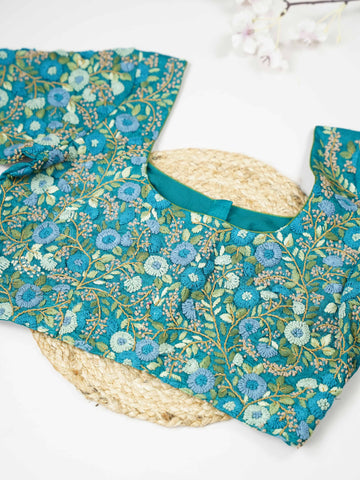 Tussar This elegant peacock blue Tussar designer blouse features finely stitched hand embroidery work. The front is adorned with small floral motifs, adding a delicate and graceful charm.br data-start=182 data-end=185The back is fully detailed with rich embroidery, showcasing intricate craftsmanship.br data-start=269 data-end=272Perfect for ethnic wear, it creates a bold, stylish, and beautifully balanced traditional look. Ira - Tussar Silk Saree | Hand Embroidered - Manoranjitham Weaves - Handloom Store