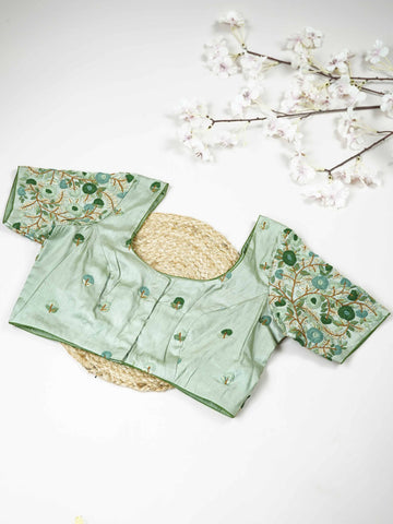 Tussar This elegant mint green Tussar designer blouse features finely stitched hand embroidery work. The front is adorned with small floral motifs, adding a soft and graceful charm.br data-start=176 data-end=179The back is fully detailed with rich embroidery, showcasing intricate craftsmanship.br data-start=263 data-end=266Perfect for ethnic wear, it creates a stylish, refreshing, and beautifully balanced traditional look. Komala - Tussar Silk Saree | Hand Embroidered - Manoranjitham Weaves - Handloom Store