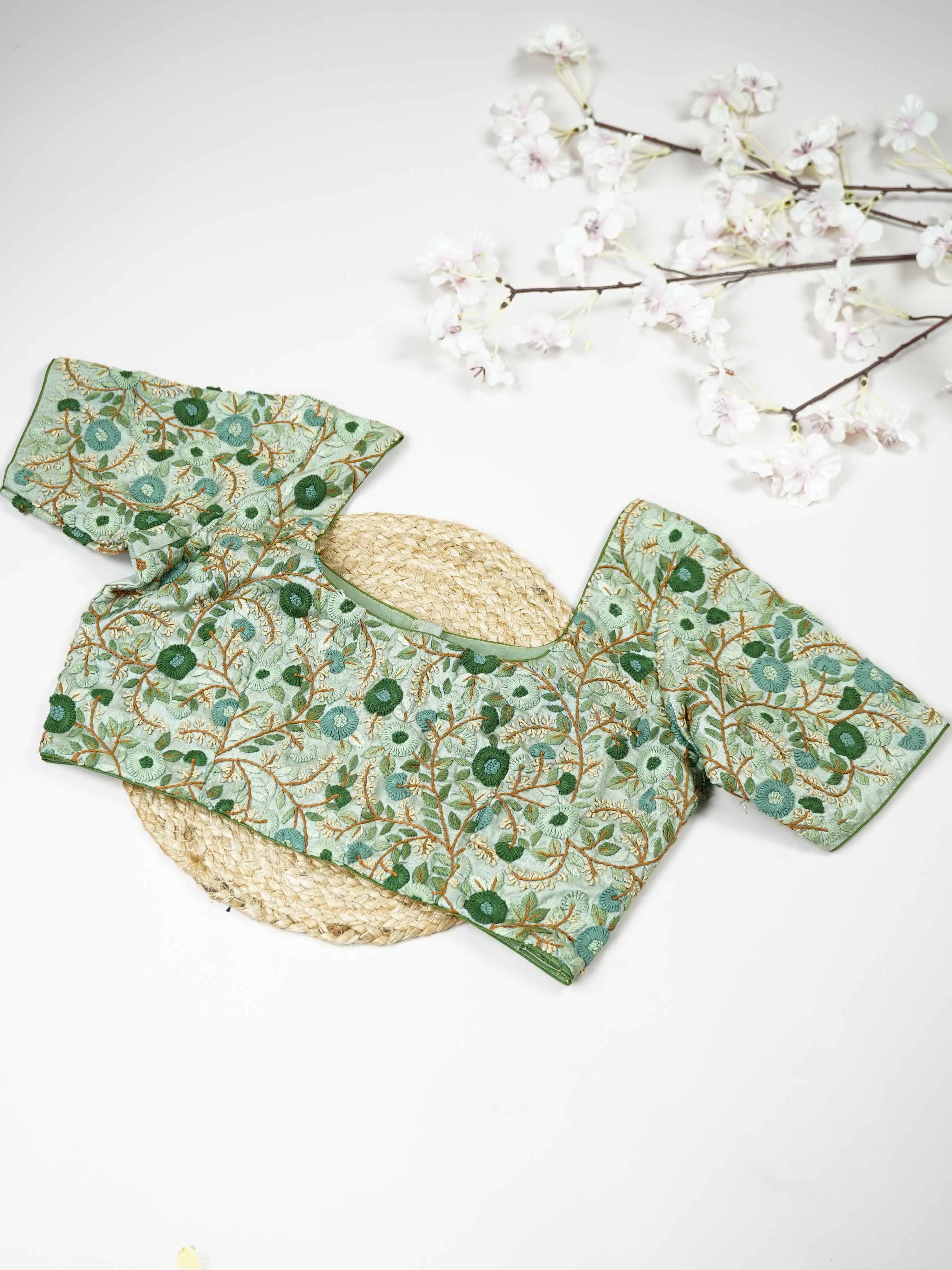 Tussar This elegant mint green Tussar designer blouse features finely stitched hand embroidery work. The front is adorned with small floral motifs, adding a soft and graceful charm.br data-start=176 data-end=179The back is fully detailed with rich embroidery, showcasing intricate craftsmanship.br data-start=263 data-end=266Perfect for ethnic wear, it creates a stylish, refreshing, and beautifully balanced traditional look. Komala - Tussar Silk Saree | Hand Embroidered - Manoranjitham Weaves - Handloom Store
