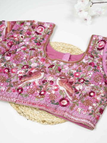 Tussar This elegant baby pink Tussar blouse features finely stitched hand embroidery work.br data-start=83 data-end=86The front is delicately designed with small floral motifs, adding a soft feminine charm.br data-start=174 data-end=177The back is richly adorned with full embroidery, showcasing detailed craftsmanship.br data-start=260 data-end=263Perfect for ethnic wear, it creates a graceful, stylish, and beautifully balanced traditional look. Iraya - Tussar Silk Saree | Hand Embroidered - Manoranjitham We