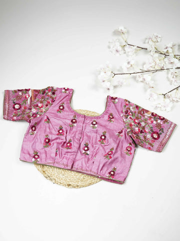 Tussar This elegant baby pink Tussar blouse features finely stitched hand embroidery work.br data-start=83 data-end=86The front is delicately designed with small floral motifs, adding a soft feminine charm.br data-start=174 data-end=177The back is richly adorned with full embroidery, showcasing detailed craftsmanship.br data-start=260 data-end=263Perfect for ethnic wear, it creates a graceful, stylish, and beautifully balanced traditional look. Iraya - Tussar Silk Saree | Hand Embroidered - Manoranjitham We