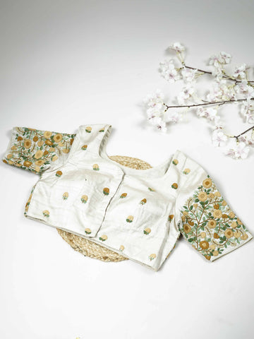 Tussar This elegant off-white Tussar blouse features finely stitched hand embroidery work.br data-start=83 data-end=86The front is delicately adorned with small floral motifs, adding a soft and graceful charm.br data-start=177 data-end=180The back is fully designed with rich embroidery, showcasing intricate handcrafted artistry.br data-start=271 data-end=274Perfect for ethnic wear, it creates a timeless, elegant, and beautifully balanced traditional look. Arohi - Tussar Silk Saree | Hand Embroidered - Manor