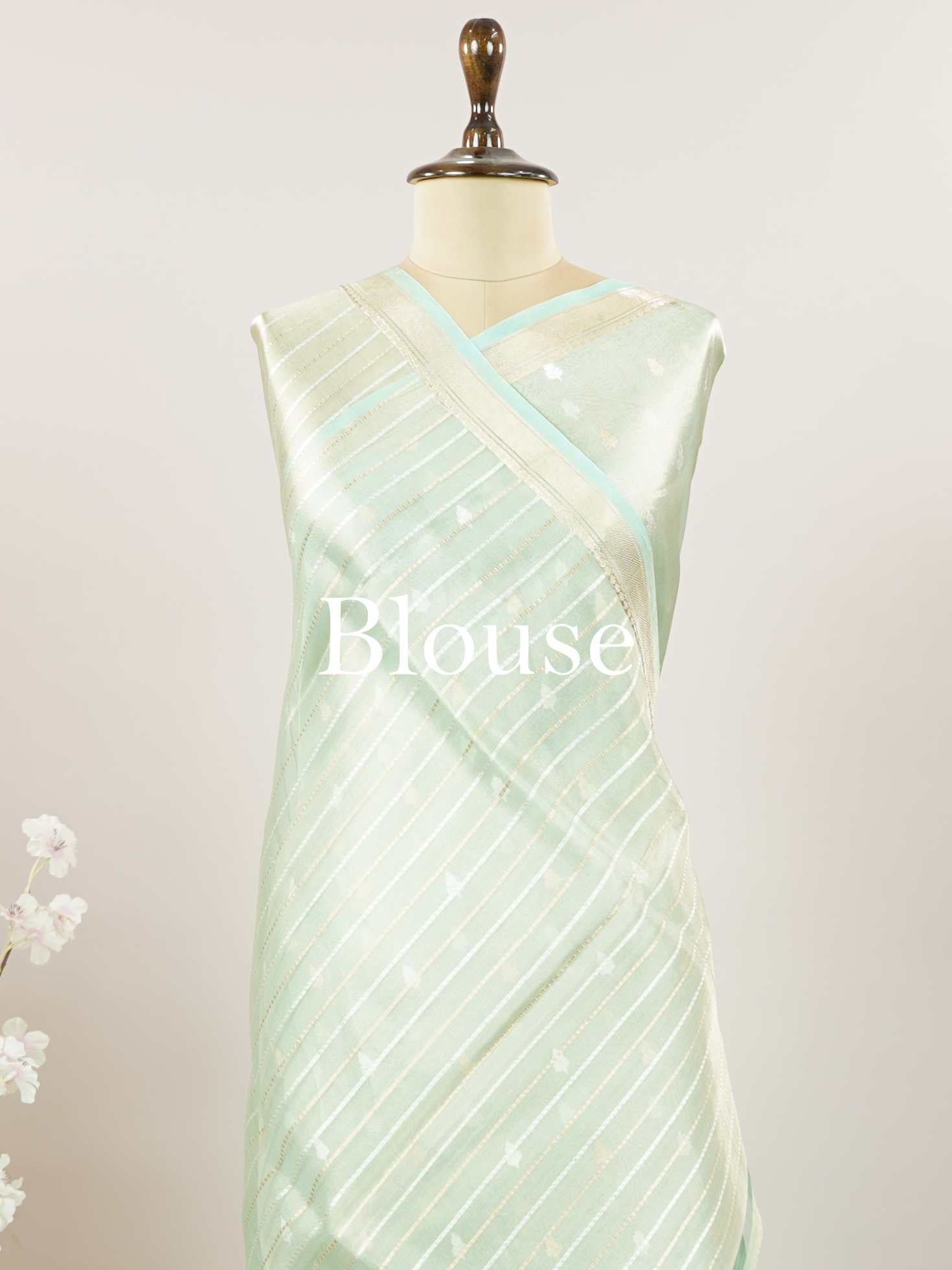 Tissue Step into subtle elegance with this tissue saree in a soothing powder green shade, paired with a matching blouse. The lightweight tissue fabric offers a soft, graceful shimmer that enhances its refined appeal. Delicate gold and silver buttas are woven throughout, adding a hint of festive charm and sophistication. Perfect for festive occasions, receptions, and elegant gatherings that call for understated beauty. Charukesi - Banarasi Tissue Kora Saree | Lightweight | Woven Buttas - Manoranjitham Weaves