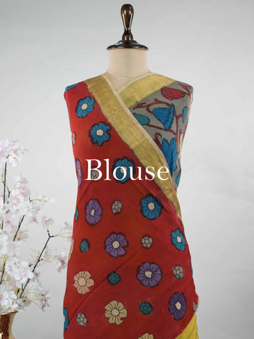 Mysore silk This Mysore silk saree is a quiet celebration of two worlds beautifully united — one half draped in the cool, understated elegance of pure grey silk, the other brought alive with intricate pen Kalamkari artistry in earthy, hand-drawn motifs. The 100% pure silk body carries that characteristic Mysore sheen, smooth and weightless against the skin, while the Kalamkari half tells a story in every careful line and curve. Zari accents frame the drape with a subtle gleam, never overpowering the artistr