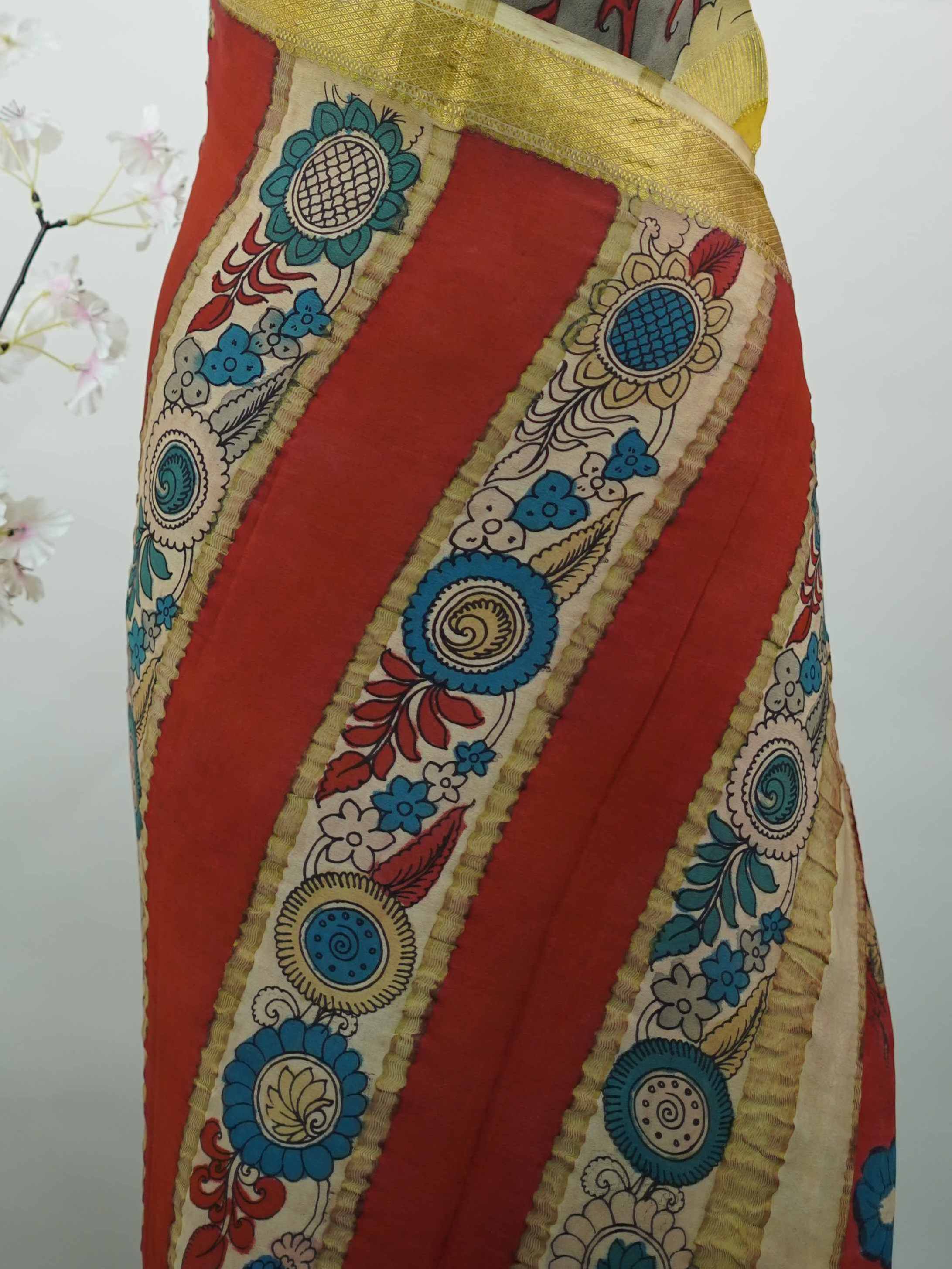 Mysore silk This Mysore silk saree is a quiet celebration of two worlds beautifully united — one half draped in the cool, understated elegance of pure grey silk, the other brought alive with intricate pen Kalamkari artistry in earthy, hand-drawn motifs. The 100% pure silk body carries that characteristic Mysore sheen, smooth and weightless against the skin, while the Kalamkari half tells a story in every careful line and curve. Zari accents frame the drape with a subtle gleam, never overpowering the artistr