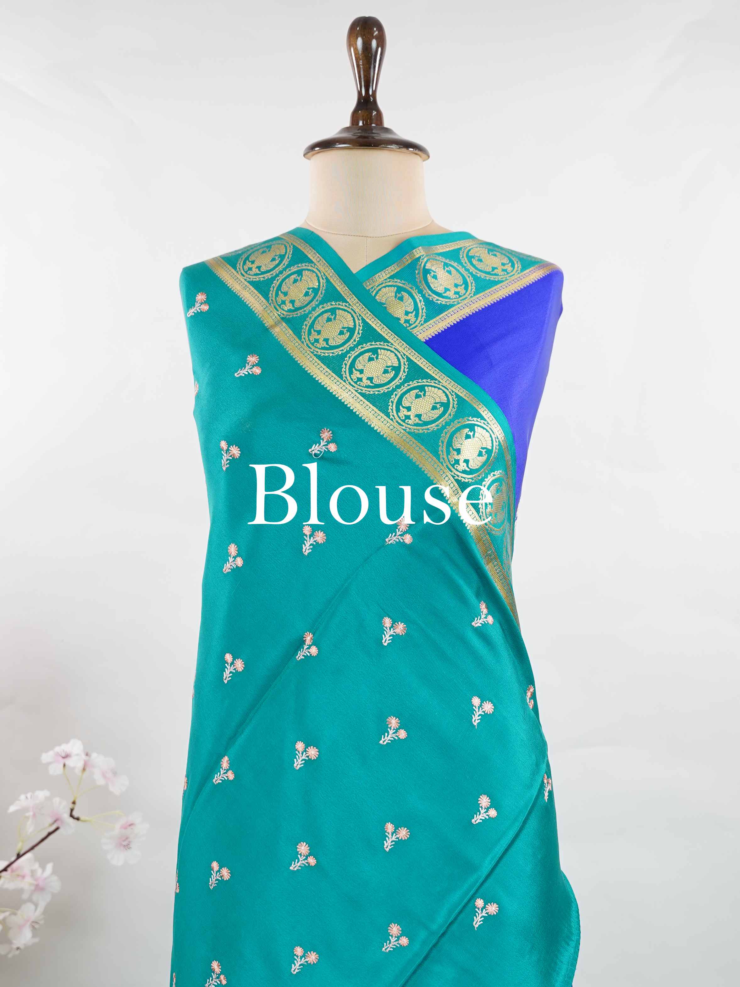 Mysore silk Rich blue Mysore silk featuring traditional checks and intricately woven Gandaberunda motifs across the body. A graceful Mysore silk saree crafted using pure handloom techniques. Its soft silk weave offers elegance with comfort. Simple styling adds timeless sophistication. Woven to reflect heritage and artistry. A beautiful saree for every occasion.brA graceful blend of heritage craftsmanship and timeless South Indian elegance. Tejomayi - Blue Pure Mysore Silk Saree | Gandaberunda Motifs - Manor
