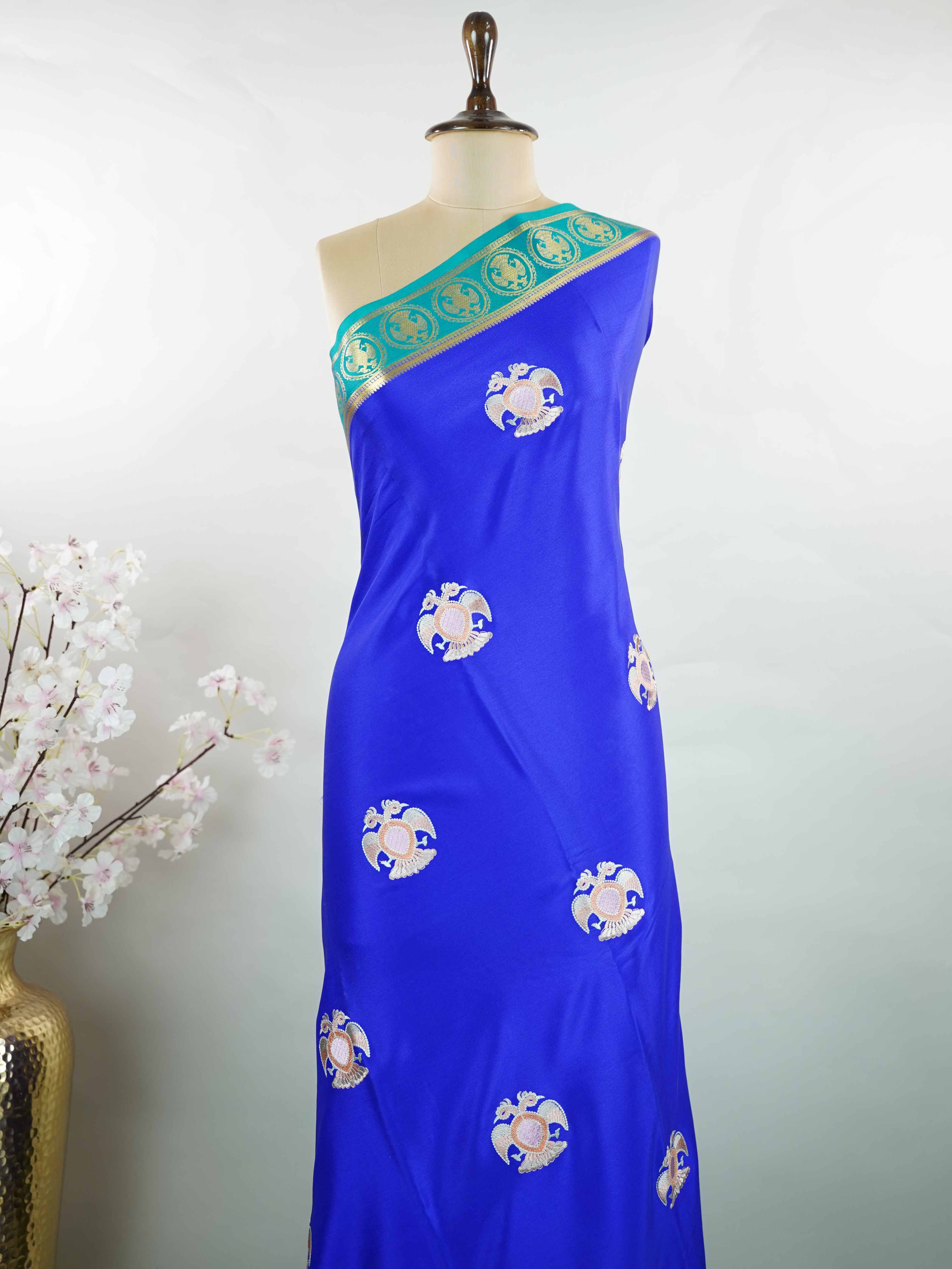 Mysore silk Rich blue Mysore silk featuring traditional checks and intricately woven Gandaberunda motifs across the body. A graceful Mysore silk saree crafted using pure handloom techniques. Its soft silk weave offers elegance with comfort. Simple styling adds timeless sophistication. Woven to reflect heritage and artistry. A beautiful saree for every occasion.brA graceful blend of heritage craftsmanship and timeless South Indian elegance. Tejomayi - Blue Pure Mysore Silk Saree | Gandaberunda Motifs - Manor