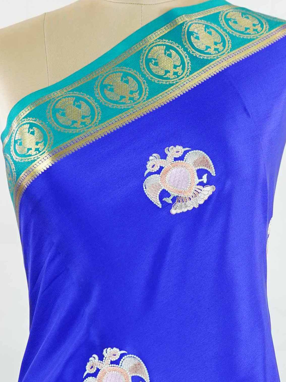 Mysore silk Rich blue Mysore silk featuring traditional checks and intricately woven Gandaberunda motifs across the body. A graceful Mysore silk saree crafted using pure handloom techniques. Its soft silk weave offers elegance with comfort. Simple styling adds timeless sophistication. Woven to reflect heritage and artistry. A beautiful saree for every occasion.brA graceful blend of heritage craftsmanship and timeless South Indian elegance. Tejomayi - Blue Pure Mysore Silk Saree | Gandaberunda Motifs - Manor