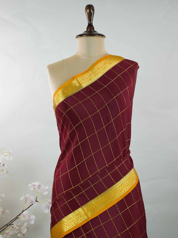 Mysore silk Pure Mysore silk in a rich maroon hue, complemented by classic checks woven gracefully across the body.br
Paired with a vibrant mustard yellow contrast, this weave exudes timeless charm and quiet sophistication. Vilasini - Maroon Pure Mysore Silk Saree | Classic Checks - Manoranjitham Weaves - Handloom Store