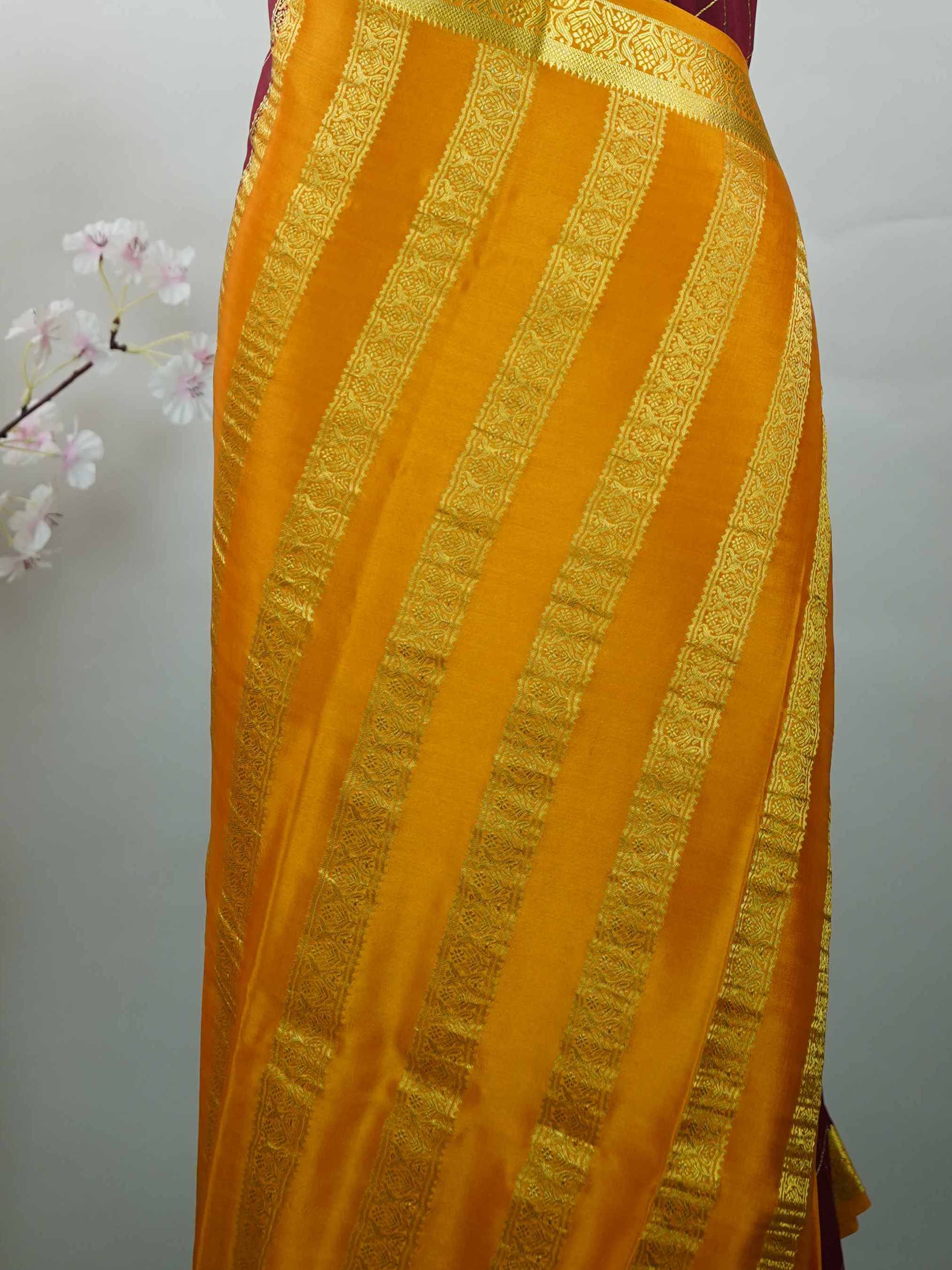 Mysore silk Pure Mysore silk in a rich maroon hue, complemented by classic checks woven gracefully across the body.br
Paired with a vibrant mustard yellow contrast, this weave exudes timeless charm and quiet sophistication. Vilasini - Maroon Pure Mysore Silk Saree | Classic Checks - Manoranjitham Weaves - Handloom Store