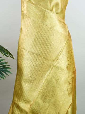 Kanchipuram Silk Beautiful bridal Kanjivaram saree featuring a rich Settled Gold body, gracefully complemented by a matching Gold border and elegant Gold pallu. The luxurious golden hue exudes timeless grandeur, creating a regal and sophisticated bridal appearance. Expertly woven with exquisite Kanjivaram craftsmanship, the saree reflects heritage, elegance, and unmatched beauty. Paired with a suitable Gold blouse, this magnificent drape is perfect for weddings, receptions, and grand traditional celebration