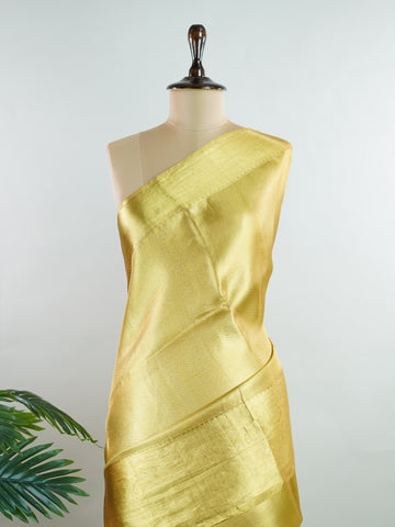 Kanchipuram Silk Beautiful bridal Kanjivaram saree featuring a rich Settled Gold body, gracefully complemented by a matching Gold border and elegant Gold pallu. The luxurious golden hue exudes timeless grandeur, creating a regal and sophisticated bridal appearance. Expertly woven with exquisite Kanjivaram craftsmanship, the saree reflects heritage, elegance, and unmatched beauty. Paired with a suitable Gold blouse, this magnificent drape is perfect for weddings, receptions, and grand traditional celebration