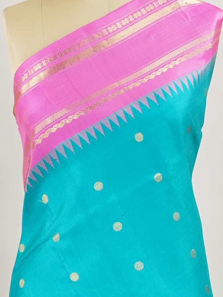Gadwal Silk This Gadwal silk saree, adorned in Cyan and detailed with Pure Zari weaving, reflects the grandeur of Gadwal. The timeless Buttis motifs enhance its bridal charm. A perfect blend of luxury and tradition, it is designed for those who appreciate fine craftsmanship. Nattakurinji - Handloom Gadwal Silk Saree - Manoranjitham Weaves - Handloom Store