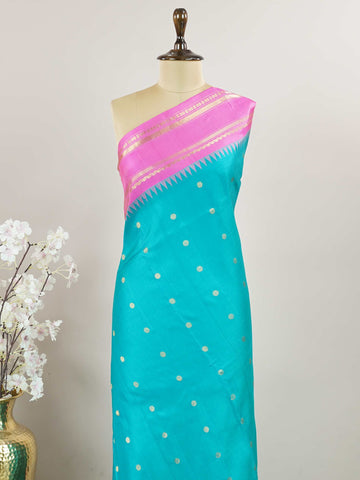 Gadwal Silk This Gadwal silk saree, adorned in Cyan and detailed with Pure Zari weaving, reflects the grandeur of Gadwal. The timeless Buttis motifs enhance its bridal charm. A perfect blend of luxury and tradition, it is designed for those who appreciate fine craftsmanship. Nattakurinji - Handloom Gadwal Silk Saree - Manoranjitham Weaves - Handloom Store