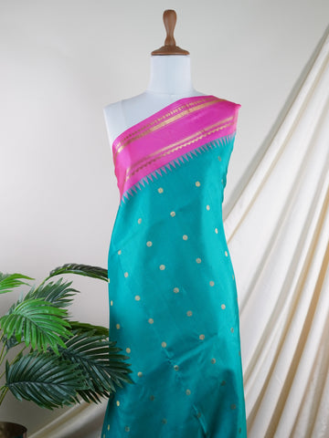 Gadwal Silk This Gadwal silk saree, adorned in Cyan and detailed with Pure Zari weaving, reflects the grandeur of Gadwal. The timeless Buttis motifs enhance its bridal charm. A perfect blend of luxury and tradition, it is designed for those who appreciate fine craftsmanship. Nattakurinji - Manoranjitham Weaves - Handloom Store