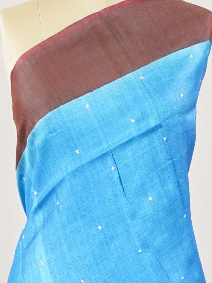 Tussars A Tussar saree with a plain upper body and digital print on the bottom border and pallu, enhanced with Aari Peeta embroidery for a subtle, handcrafted charm. Desha - Tussar Silk Saree | Digital Print - Manoranjitham Weaves - Handloom Store