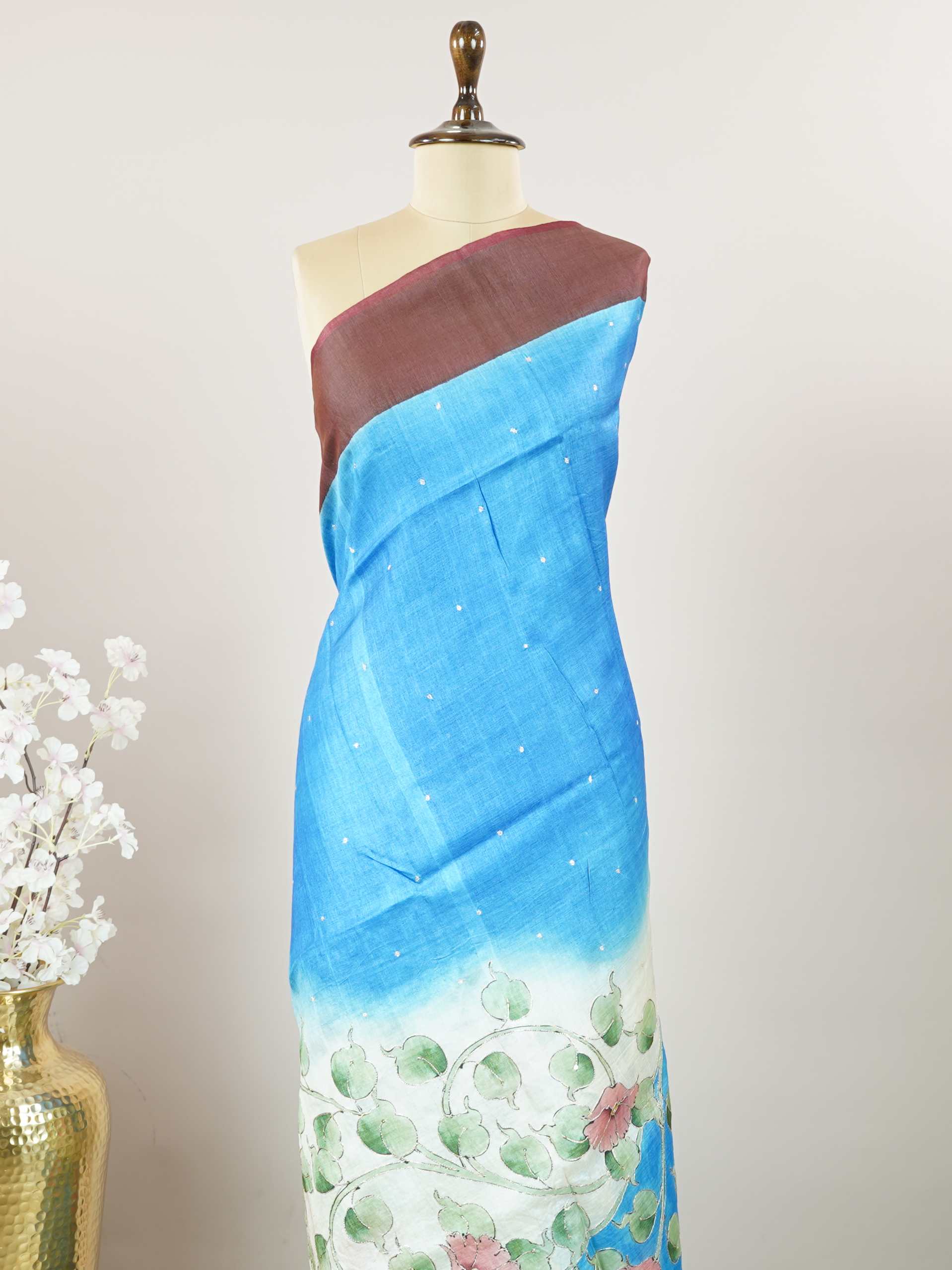 Tussars A Tussar saree with a plain upper body and digital print on the bottom border and pallu, enhanced with Aari Peeta embroidery for a subtle, handcrafted charm. Desha - Tussar Silk Saree | Digital Print - Manoranjitham Weaves - Handloom Store