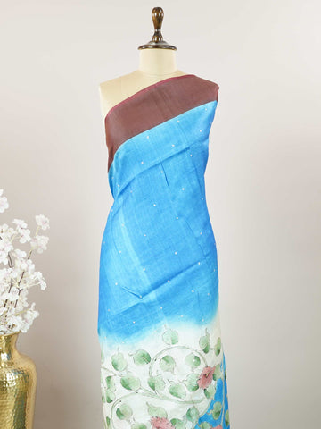 Tussars A Tussar saree with a plain upper body and digital print on the bottom border and pallu, enhanced with Aari Peeta embroidery for a subtle, handcrafted charm. Desha - Tussar Silk Saree | Digital Print - Manoranjitham Weaves - Handloom Store