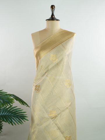 tissue This Kora Semi Tissue saree in rich gold features elegant stripes woven with fine zari. Lightweight and luminous, it captures the essence of festive finesse. Crafted in Varanasi, it drapes with ease and radiance. A timeless choice for celebrations with subtle grandeur. #KoraSemiTissue #GoldStripes #FineZari #VaranasiWeaves #ManoranjithamSarees Manasa - Gold Semi Silk Saree - Manoranjitham Weaves - Handloom Store