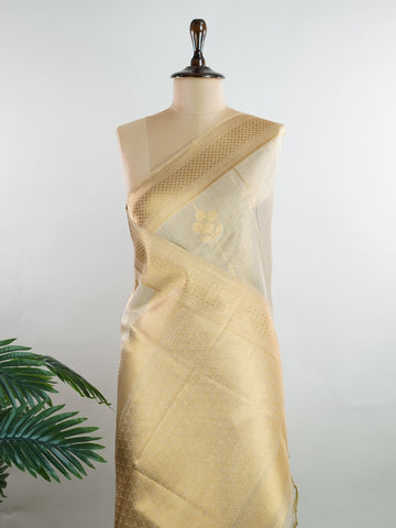 tissue This Kora Semi Tissue saree in rich gold features elegant stripes woven with fine zari. Lightweight and luminous, it captures the essence of festive finesse. Crafted in Varanasi, it drapes with ease and radiance. A timeless choice for celebrations with subtle grandeur. #KoraSemiTissue #GoldStripes #FineZari #VaranasiWeaves #ManoranjithamSarees Manasa - Gold Semi Silk Saree - Manoranjitham Weaves - Handloom Store