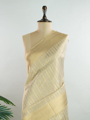 tissue This Kora Semi Tissue saree in rich gold features elegant stripes woven with fine zari. Lightweight and luminous, it captures the essence of festive finesse. Crafted in Varanasi, it drapes with ease and radiance. A timeless choice for celebrations with subtle grandeur. #KoraSemiTissue #GoldStripes #FineZari #VaranasiWeaves #ManoranjithamSarees Gautami - Manoranjitham Weaves - Handloom Store
