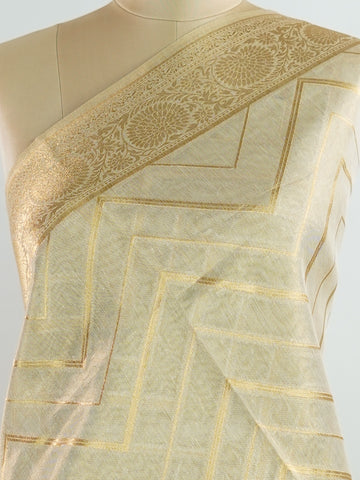 tissue This Kora Semi Tissue saree in rich gold features elegant stripes woven with fine zari. Lightweight and luminous, it captures the essence of festive finesse. Crafted in Varanasi, it drapes with ease and radiance. A timeless choice for celebrations with subtle grandeur. #KoraSemiTissue #GoldStripes #FineZari #VaranasiWeaves #ManoranjithamSarees Vasanti - Gold Semi Silk Saree - Manoranjitham Weaves - Handloom Store