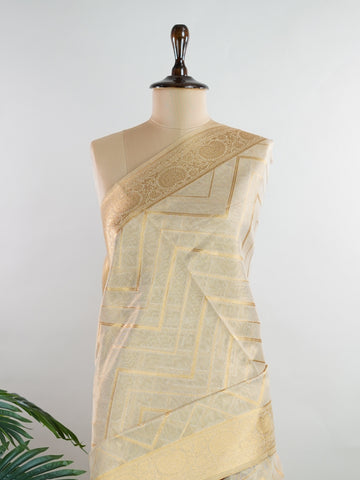 tissue This Kora Semi Tissue saree in rich gold features elegant stripes woven with fine zari. Lightweight and luminous, it captures the essence of festive finesse. Crafted in Varanasi, it drapes with ease and radiance. A timeless choice for celebrations with subtle grandeur. #KoraSemiTissue #GoldStripes #FineZari #VaranasiWeaves #ManoranjithamSarees Vasanti - Gold Semi Silk Saree - Manoranjitham Weaves - Handloom Store