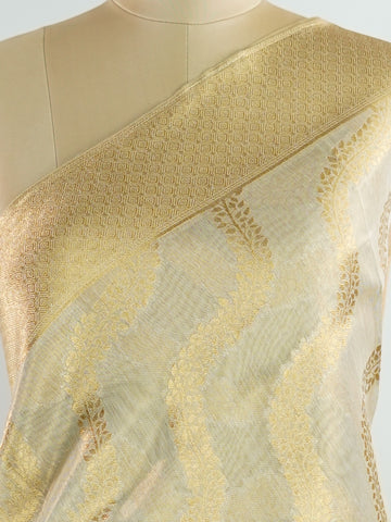 tissue This Kora Semi Tissue saree in rich gold features elegant stripes woven with fine zari. Lightweight and luminous, it captures the essence of festive finesse. Crafted in Varanasi, it drapes with ease and radiance. A timeless choice for celebrations with subtle grandeur. #KoraSemiTissue #GoldStripes #FineZari #VaranasiWeaves #ManoranjithamSarees Yashoda - Gold Semi Silk Saree - Manoranjitham Weaves - Handloom Store