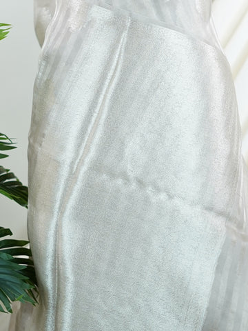 tissue Woven with the finest silk, this 100% Pure Silk  saree in Mint Green blends tradition and grace. Its Gold and Silver Zari Buttas detailing adds a touch of bridal opulence. Bhinnashadja - Mint Green Banarasi Tissue Kora Saree | Zari Buttas - Manoranjitham Weaves - Handloom Store