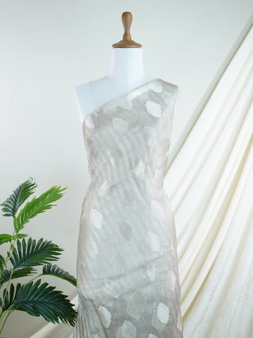 tissue Woven with the finest silk, this 100% Pure Silk  saree in Mint Green blends tradition and grace. Its Gold and Silver Zari Buttas detailing adds a touch of bridal opulence. Bhinnashadja - Mint Green Banarasi Tissue Kora Saree | Zari Buttas - Manoranjitham Weaves - Handloom Store