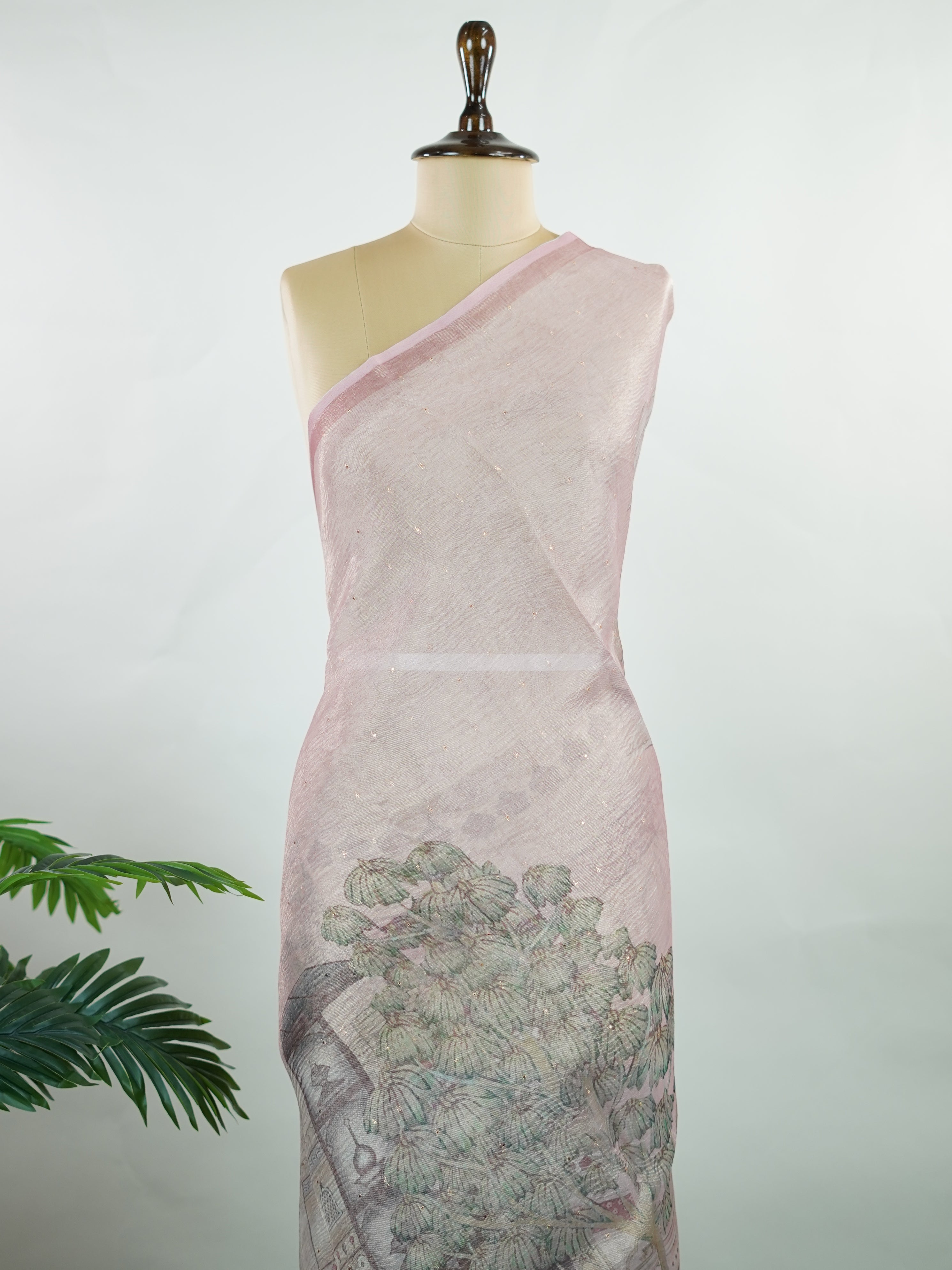 tissue A delicate Banaras Tissue saree woven in the heritage looms of Varanasi, this piece captures the timeless shimmer of fine zari work on a lightweight, translucent base. The luminous fabric drapes effortlessly and catches the light beautifully, making it an ideal choice for festive gatherings, pujas, and celebrations. Its airy texture keeps you comfortable while the subtle zari detailing adds a touch of understated elegance. tissue - Semi Silk Saree - Manoranjitham Weaves - Handloom Store