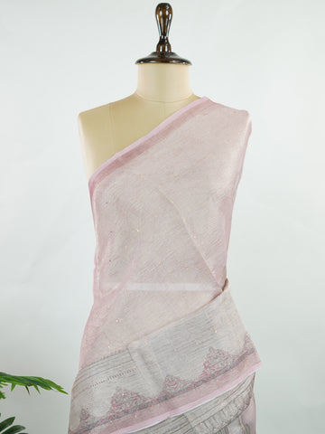 tissue A delicate Banaras Tissue saree woven in the heritage looms of Varanasi, this piece captures the timeless shimmer of fine zari work on a lightweight, translucent base. The luminous fabric drapes effortlessly and catches the light beautifully, making it an ideal choice for festive gatherings, pujas, and celebrations. Its airy texture keeps you comfortable while the subtle zari detailing adds a touch of understated elegance. tissue - Semi Silk Saree - Manoranjitham Weaves - Handloom Store
