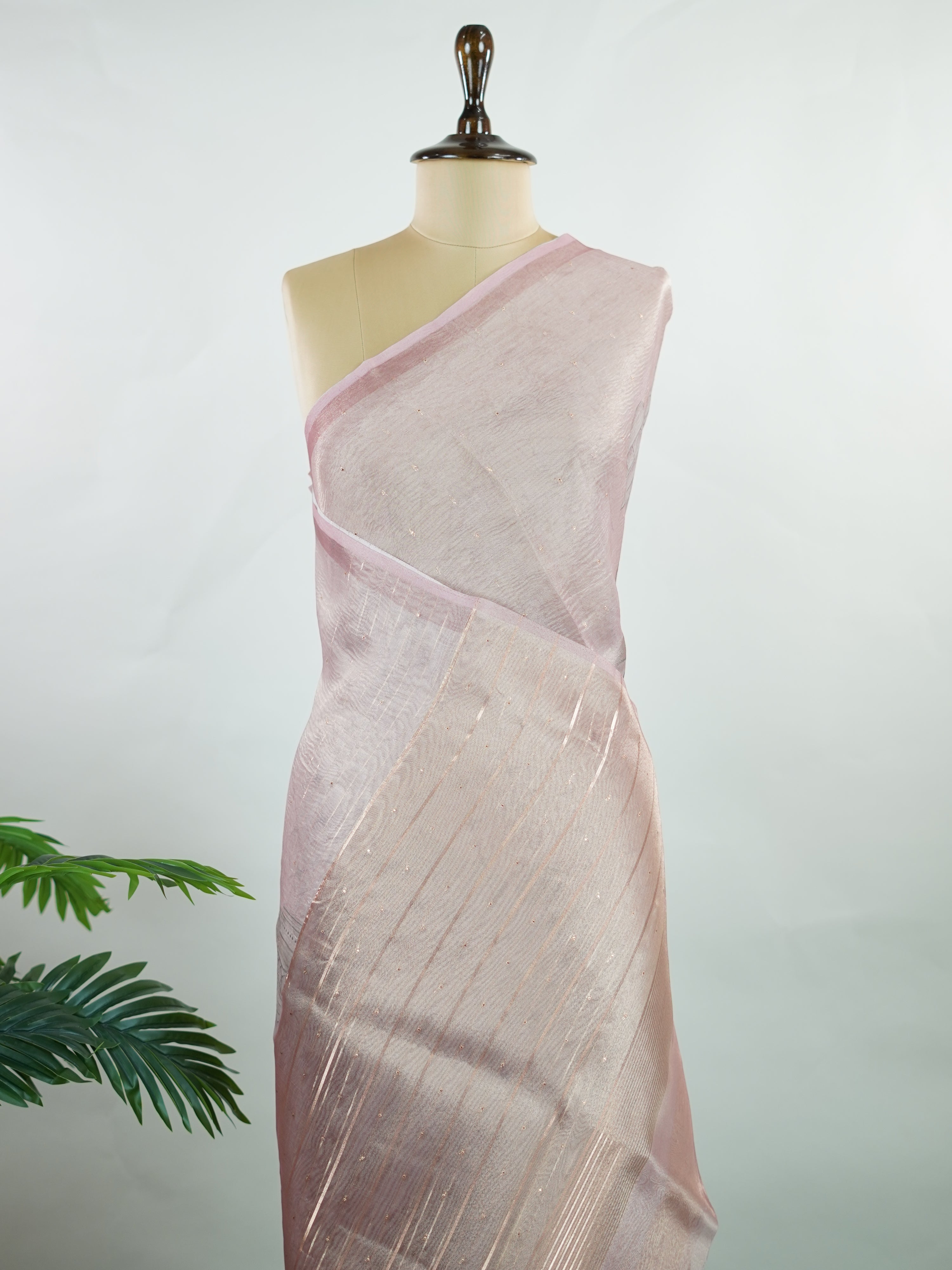 tissue A delicate Banaras Tissue saree woven in the heritage looms of Varanasi, this piece captures the timeless shimmer of fine zari work on a lightweight, translucent base. The luminous fabric drapes effortlessly and catches the light beautifully, making it an ideal choice for festive gatherings, pujas, and celebrations. Its airy texture keeps you comfortable while the subtle zari detailing adds a touch of understated elegance. tissue - Semi Silk Saree - Manoranjitham Weaves - Handloom Store