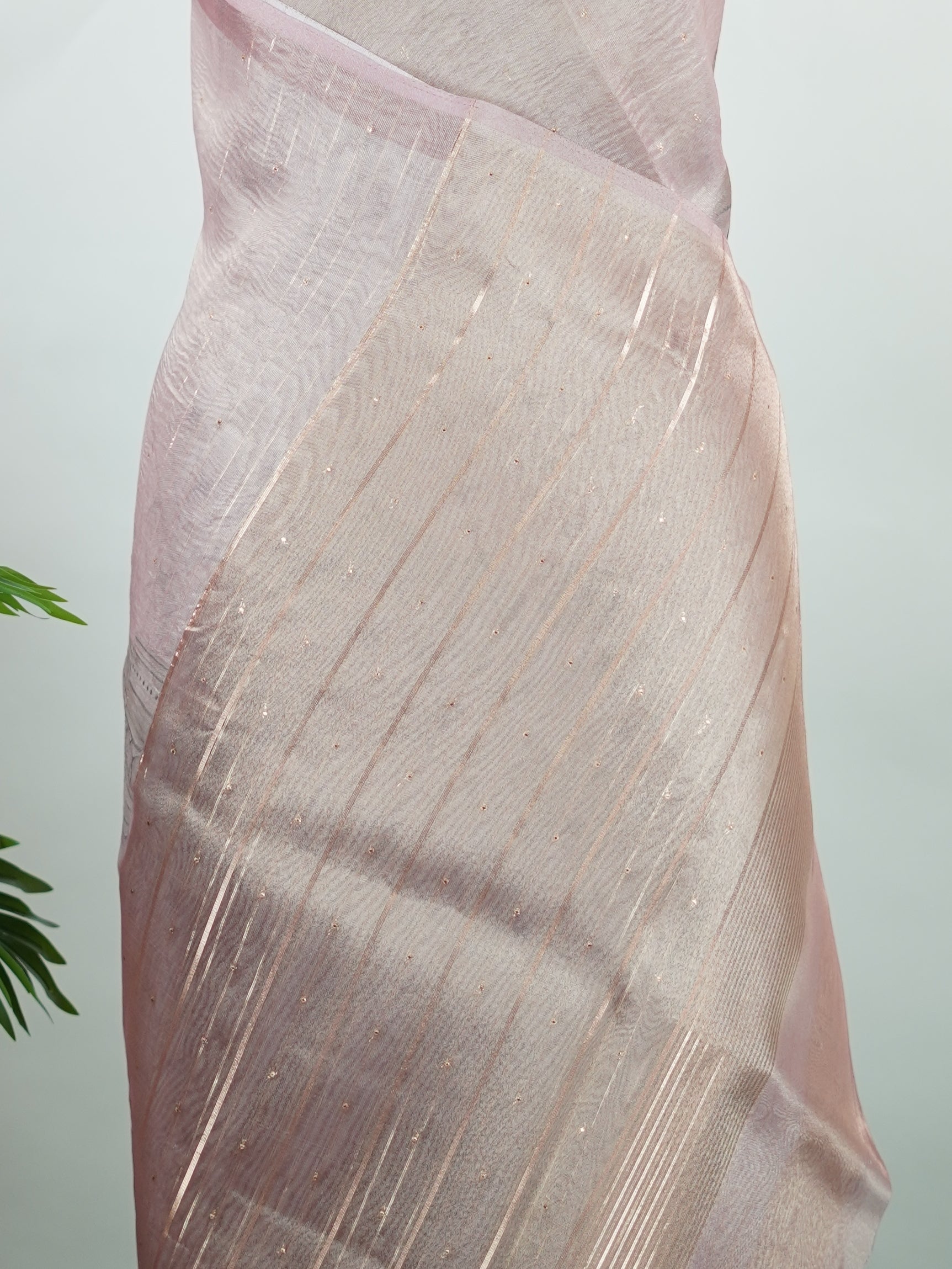 tissue A delicate Banaras Tissue saree woven in the heritage looms of Varanasi, this piece captures the timeless shimmer of fine zari work on a lightweight, translucent base. The luminous fabric drapes effortlessly and catches the light beautifully, making it an ideal choice for festive gatherings, pujas, and celebrations. Its airy texture keeps you comfortable while the subtle zari detailing adds a touch of understated elegance. tissue - Semi Silk Saree - Manoranjitham Weaves - Handloom Store