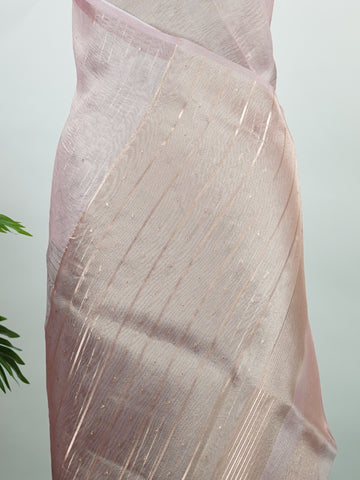 tissue A delicate Banaras Tissue saree woven in the heritage looms of Varanasi, this piece captures the timeless shimmer of fine zari work on a lightweight, translucent base. The luminous fabric drapes effortlessly and catches the light beautifully, making it an ideal choice for festive gatherings, pujas, and celebrations. Its airy texture keeps you comfortable while the subtle zari detailing adds a touch of understated elegance. tissue - Semi Silk Saree - Manoranjitham Weaves - Handloom Store